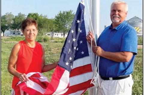 Gail and Dennis Bazata send up the flag