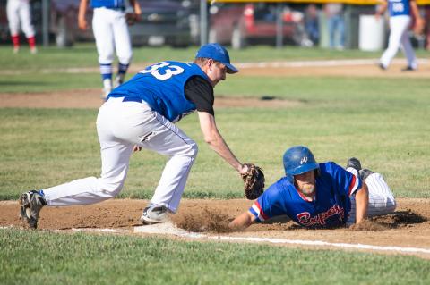 Wynot Expos's Don Whitmire slides back into first base during a game against Crofton at the districts tournament in Lesterville. Photo by Elsie Stormberg