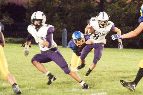 Hartington-Newcastle’s Kobe Heitman tries to shake off an Allen tackler during early action Friday night.