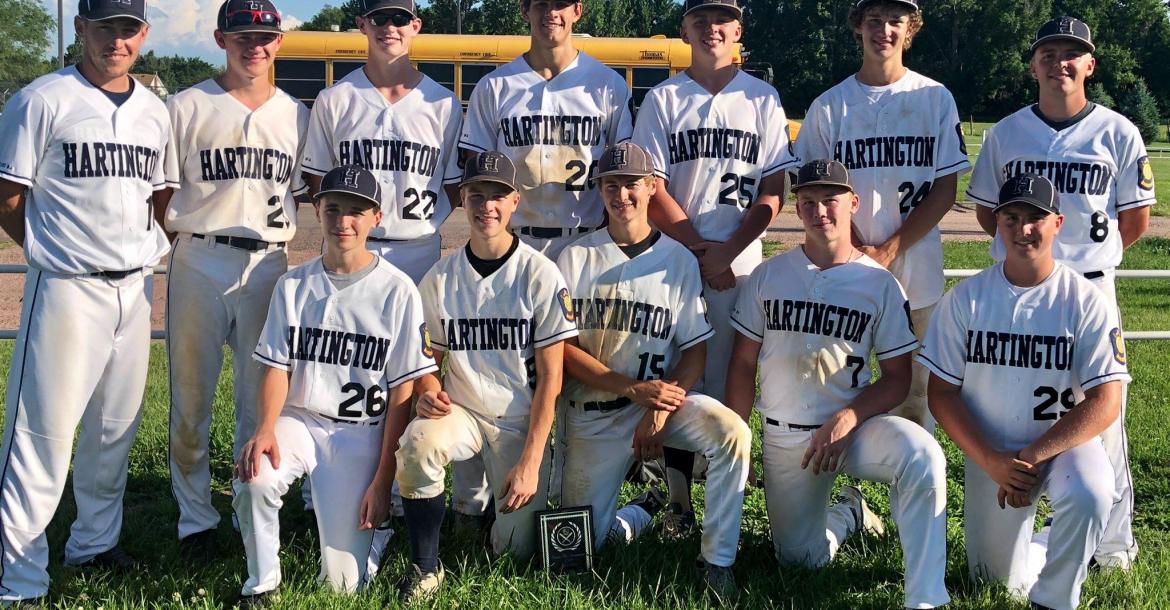 The Hartington Juniors pose with the Creighton Wooden Bat Tournament plaque after defeating O'Neill and Creighton on Saturday to win the tournament. Photo Credit Lori Bengston