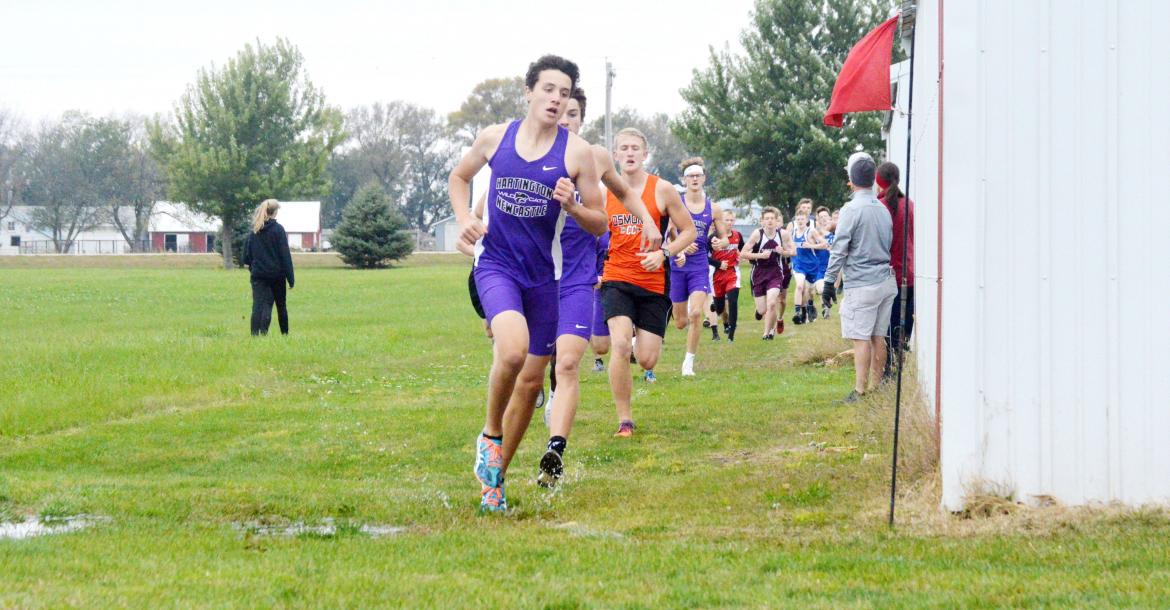 Hartington-Newcastle cross country runners Riley Kuehn and Dagen Joachimsen race around the corner at the beginning of last week's Lewis and Clark Conference race at Rolling Hills Golf Course in Wausa