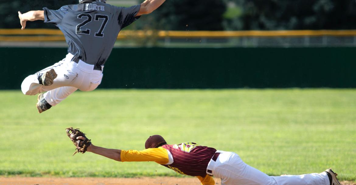 Turner Korth hurdles over a page from Neligh's Cole Belitz during a Sr. Legion game